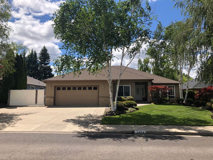 A perfect blend of comfort and luxury. Upon entering, you'll find a spacious living room enhanced by 10' ceilings, creating an inviting sense of openness. The main bedroom features a walk-in closet and a slider to the patio, offering easy access to outdoor relaxation. The bathroom is equipped with a Jacuzzi tub. The property comes with an oversized, fully insulated garage, complete with a belt drive opener for quiet, smooth operation. For RV owners, the property provides full-sized RV access with a sturdy, level cement pad and RV electric and water hookups. The backyard is a visual treat, especially in spring when the flowers bloom in a vibrant array of colors. It features a built-in BBQ with matching fireplace rock, perfect for outdoor entertaining. The waterfall and unique landscaping enhance the beauty of the outdoor spaces, offering a serene environment for relaxation or social gatherings. The property is also prewired for satellite and surround sound.