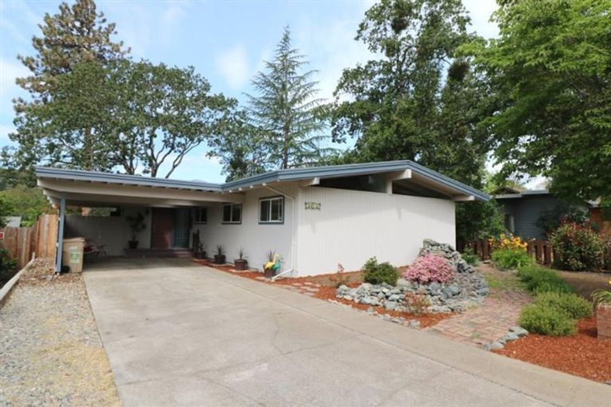 Entertainer's Paradise! Mid century modern style home with flowing floorplan, extensive multi-level decking, above ground pool and views! Relax by the pool or host a BBQ and have room for everyone. The inviting open great room is a wonderful gathering spot and features an island kitchen with raised bar, vaulted ceiling with wood beams, solid wood floors, large picture windows, gas stove and 2 sets of doors leading to the decks. There's also 4 bedrooms and 2.5 baths including the large basement level room that could be a great home office or recreation room and has a closet, storage and doors to the lower deck. The master bedroom also has vaulted and beamed ceilings, double closets and private bathroom with double sinks and step-in shower. The home is complete with attached carport, detached 2 car garage with access from Gilbert Way, laundry room and is beautifully landscaped with a water feature in the front yard. Located in town with city schools and services.