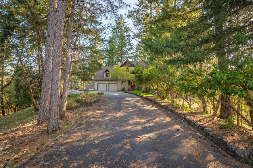 Are you looking for peace, quiet & seclusion with breathtaking views! Tucked up a gated & paved driveway you will find this beautifully maintained 2,470sf, 3 bedroom, 2.5 bath home built in a forested 5 acre setting with magnificent mountain & valley views! Remodeled kitchen with hardwood floors, granite counters, wall oven, cooktop, Bosch dishwasher, pantry & dining area! Spacious living room with a wood burning fireplace & astounding views. 400 sf bonus/game room with pellet stove over the garage. Wrap around covered redwood porch and Gorgeous decks let you entertain in the woods! The huge primary bedroom with it's Queen Anne's turret has a bird's eye view of the distant Rogue River & Robertsons Bridge! The tiled master shower is exquisite! Attached oversize 2-car garage plus covered 35-foot RV parking! It's like living at a vacation resort! Completely fenced property, with security gate & whole house back-up generator! Laundry room with mud sink, and a laundry chute.