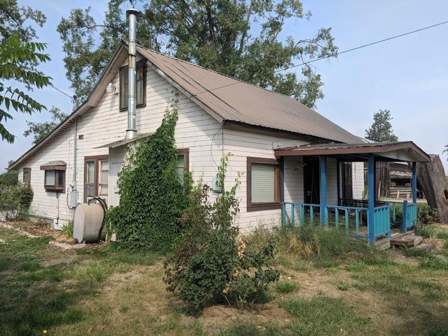 This old farmhouse has charm, character and potential! Over 1100 sq. ft with 2 bedrooms downstairs and a huge bonus room upstairs. There is also a bathroom on the main floor. A lot of wood in this home adding to the charm. Huge kitchen as well as a great office or back study. A lot of outbuildings, an old water tower, shop, barn, sheds and chicken coops. Garden and a small pear orchard all sitting on over two acres.