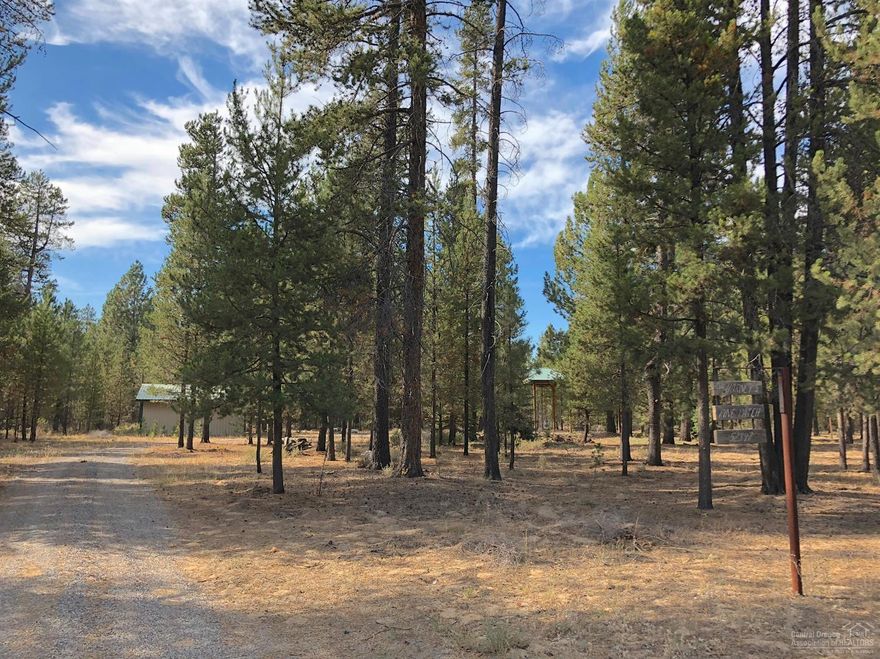 Nicely improved 1.1 acre parcel includes private well and upgraded electric to a 480 sq ft shop/storage building, concrete RV pad with metal roof, and well enclosure. Sweeping circular driveway and mature ponderosas offer an ideal setting for convenient RVing or building that new vacation or full-time home near renowned Central OR high lakes, skiing, hiking and fishing!