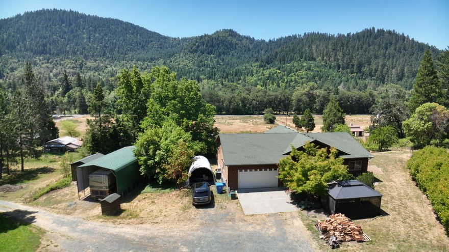 Ready for the Oregon lifestyle?  This Home which has that cabin feel has views of the mountains, just 15 mins to Grants Pass and has recreation all around you.  This property has just the right sized home with the right amount of land.   Great open floor plan with vaulted ceilings and views.  Hardwood floors, granite counters, split floor plan with Primary bedroom and bath on one side and two others with a bath on the other side.  Nice deck with great views.  Enclosed gazebo area, with ample yard for pets.  RV storage with full hookups and covered.  Shed for all your lawn equipment.  Private driveway with room for guests.  This is truly nature at its best with all close by.  This is the first sale in 20 years and this home has been well taken care of.  Make an appt to see today with all the extras.