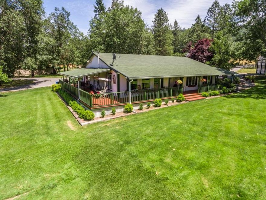 Remarkable horse property in the desirable Applegate Valley with a custom-built home! This 3Bed/2Bath Ranch style house has a welcoming wrap around porch. Custom wood cabinets in the kitchen, an energy efficient certified pellet stove, wood floors, French doors, hardwood floors, and mud room. All these features and others display the homes practicality and warmth. Fully fenced and crossed fenced with gated entry and security cameras. Well built and maintained 4-Stall Barn with Tack room will have any horse lover or small farmer excited. Not to mention the massive RV port with additional room for a large trailer. RV hookups as well! Covered hay storage and horse arena. Detached garage with oversized doors have plenty of room for your vehicles or can be transformed into a fantastic shop. Property is irrigated by the Ground Water Right which covers over 4 of the 5 acres. Perfect horse property or small farm ready to go. Do not let this one slip through your hands!