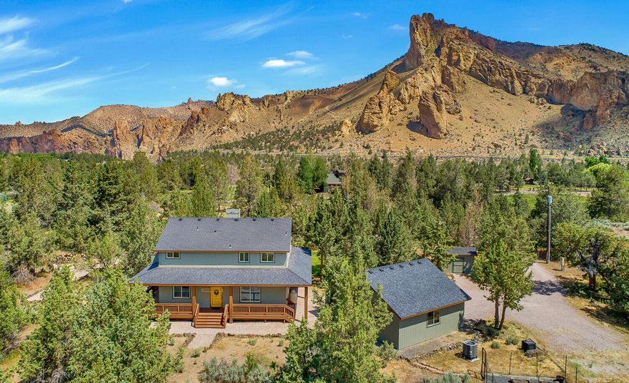 Turnkey home on 4.3 acres with irrigation rights, less than 1/2 of a mile to the Smith Rock State Park parking area via a dead-end, private dirt road. Stunning views from almost every window! On the ground floor you will step into a great room with a wood burning stove, open functional kitchen, private office, and half bath. Upstairs find the light-filled primary bedroom with its own deck to take in the views of Smith Rock and the Cascade mountains. Two more nice sized bedrooms, full bathroom, and a laundry area round out the upper level flow. Enjoy epic sunsets on the wraparound deck, or gathered around the fire pit gazing up at the stars. Large detached garage with plenty of space for cars and storage. Next to the deer-fenced garden is a flat area that would be perfect for an additional shop.This home is a private oasis, move in ready, and awaiting its new caretakers!