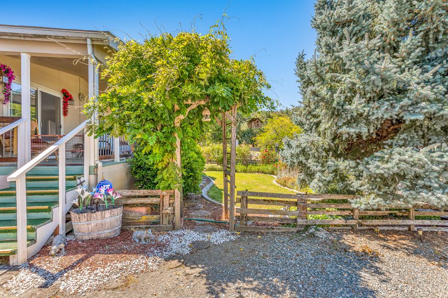 PRICE IMPROVEMENT!  Located on desirable Old Stage Road in the Nestled Hills 55+ community, with a country feel and views of the west hills.   This beautiful 3 bed/2 bath 2002 built 1596 sq ft home is one you won't want to miss. You will love the landscaped front yard, large covered front porch & the backyard w/ patio area, garden beds & large shed/workshop. The home is light and bright, w/ vaulted ceilings throughout & laminate flooring in kitchen, dining room & living room. Kitchen features a lg skylight , gas range, abundance of cabinets & counter space with eating bar. Primary bedroom boasts an extra large walk in closet, an en-suite bathroom with dual vanities, walk-in shower & a soaking tub.  Double car carport provides ample parking & extra storage area.   Buyers to be approved by park.  Space rent is only $510 per month, includes water & septic & RV parking at no additional charge per CPM Property Management.