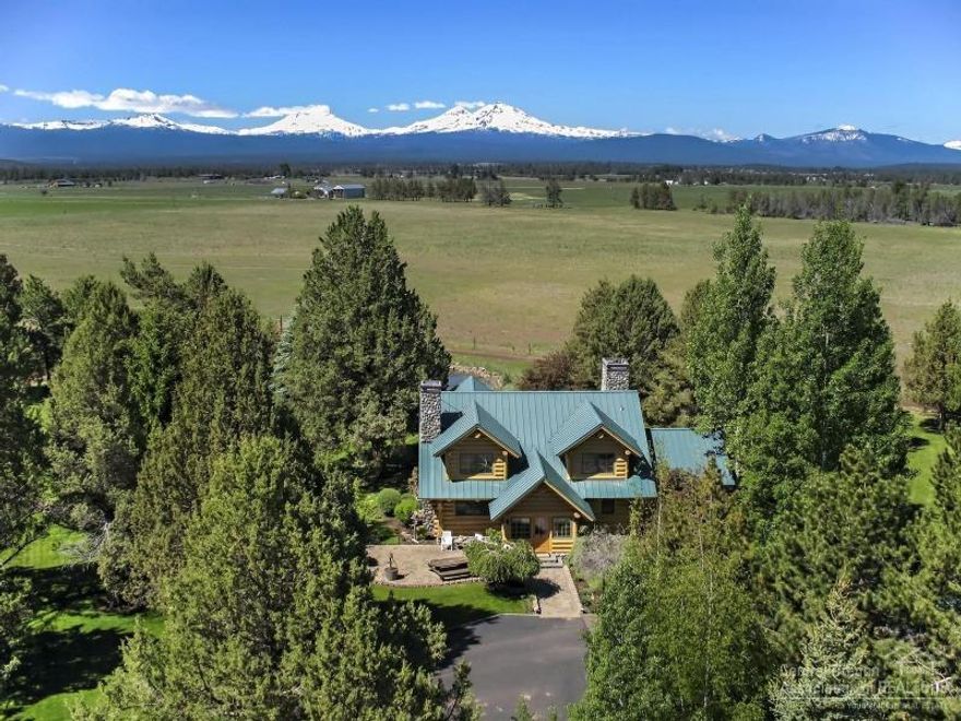 Gorgeous handscribed log home in a private setting on 30 acres with breathtaking Cascade Mountain views. Cook's kitchen features Chinkapin oak cabinets, granite counter tops and antique-style wood cook stove with river rock surround. Two-story living room with fireplace opens onto covered deck, fire pit & hot tub. Property includes: 4-stall barn, tack room, hay storage, 3 room bunkhouse,full bath, shop/equipment storage, gazebo, koi pond, 2 fenced pastures, 5 acres irrigation, adjacent to public lands.