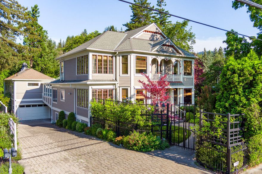 This historic Italianate home, originally designed for Domingo Perrozi in 1902, has undergone $550,000 in recent improvements, seamlessly blending the style of that historic era w/modern luxury. Located in the Heart of Ashland, adjacent to the downtown plaza, Lithia Park, restaurants & trails, it offers a stunning & serene setting. Upon entering, you are greeted by original period details, including a grand staircase, rounded arches, solid wood flooring, stained glass, bay windows & intricate moldings. The island kitchen features a sub-zero refrigerator, butler's pantry & breakfast room. W/4 bedrooms, 3 ensuite, the expansive primary bedroom has beautiful natural light from large windows overlooking lush gardens & a relaxing saline pool w/waterfalls. The property is accessible via an elevator that connects the main floor areas to the recently expanded 4-car garage & ground level. The lower level includes a spacious living/bonus/recreation area, a sauna &  direct access to the garden.