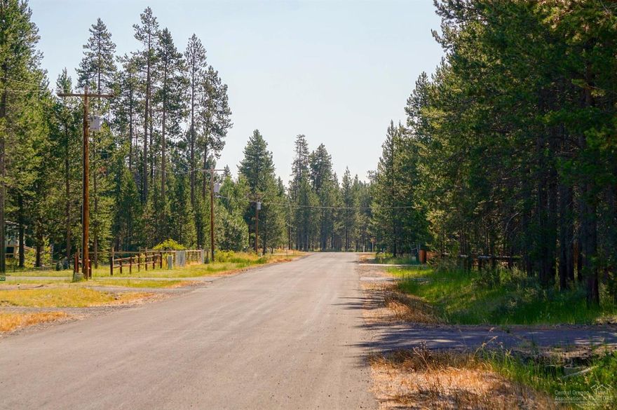 Nicely treed flat lot in excellent location. Quiet area of well kept properties. Paved road. Enjoy deeded access to the Big Deschutes River via private community marina, boat ramp & dock just blocks away.