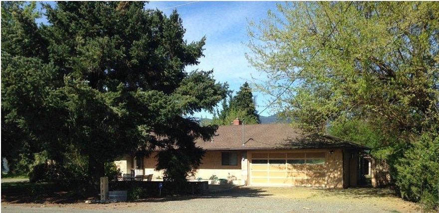 Single level home located in Grants Pass School District, on.43 of an acre cul de sac street. Majestic cedar and fir trees shade large, inviting front patio with water feature. Leaded glass entry door leads to comfy living room w/large picture window to large backyard with fruit trees, covered patio, garden shed and fenced garden area. Home has been updated with double paned windows, wood and tile floors and large bathroom with spa tub and view windows. Garage leads to large utility/mud room w/built-in cabinets and sink. Large lot allows for additional boat and toy parking.ADT alarm system installed.