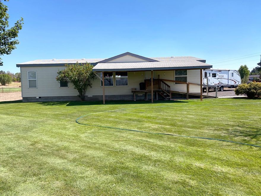 AMAZING Mountain Views! Perfect location between Redmond and Terrebonne. 4.85 acres with 2 irrigated acres planted in pasture grass. 46k gallon irrigation pond with bass in it. Well taken care of 1,430 sq.ft 3 bed 2 bath home. Large 1040 sq ft triple and detached garage & shop has built in work benches. Fenced, landscaped , fruit trees, large storage shed  & 3 raised garden beds.