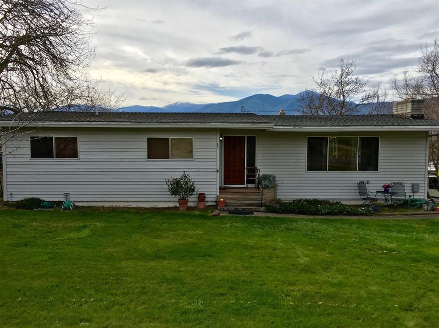 Fabulous location with incredible views. This 3 bedroom, 3 bath, farm house features beautiful newly refinished hard wood floors, step down living room with fireplace & wood stove, family room/office with slider to sun porch, formal dining room with slider to sun porch, large kitchen with stainless appliances and plenty of counter space with pass through to dining room & spacious enclosed sunroom to enjoy all year round. Each bedroom has ceiling fans and beautiful wood paneled ceilings. There are newer vinyl sliding doors and storm windows. Stairs in the hall down to the basement with storage and 2 car garage. Go outside to a spacious trex deck with hot tub and outdoor entertaining. The yard has a Japanese maple tree, 3 walnut, 1 cherry, 2 plum & 1 hazelnut, above ground pool, horseshoes, picnic table, wisteria, swing & tree house. A big red barn for the animal lovers & pasture for horses, sheep or cows, fenced & cross fenced with flood irrigation. All this on 4.16 acres.