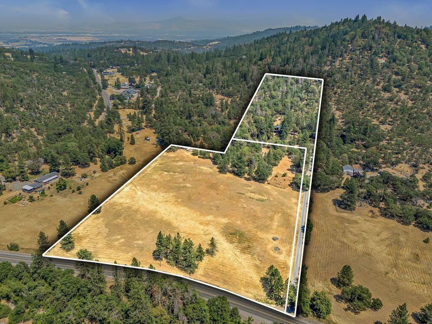 First time on the market, owner/builder put his heart & soul into this Cedar Sided home. Situated back off the Hwy on a knoll to capture the beautiful views. Two separate tax lots, undeveloped lower lot is 8.11 ac, RR Zoned, check with county for potential development. The upper 5.08 ac includes the custom home. The main living room, kitchen, along w/ 2 bds & 2 bth are on upper level for easy living. Custom kitchen features granite counters, alder cabinets, copper hood over a Viking range, slide out pantry & breakfast bar. Living room has floor to ceiling windows along w/ an energy efficient Blaze King wood stove. The open floor plan offers easy access out to the large covered deck to enjoy this peaceful setting. Lower level/daylight basement includes 3rd bd, shop, laundry, 1/2 bath, wine cellar & a single car garage. The woodlot has been well managed. Just minutes out of Historic Jacksonville & local wineries. Some photos virtually staged. Seller to credit $10,000 Flooring allowance.