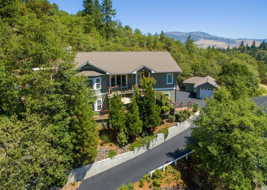 This lovely 3+ bedroom, 3 bath, two-level home of 3500 SF, graces a third of an acre in one of Ashland's most desirable locations. Sheltered by oaks and cedars, the property occupies a commanding south-facing position overlooking Lithia Park valley. Stunning views of forested hillsides and private woodland are a pleasure from just about every room, delightful cozy alcove and expansive deck. The home radiates quality. Meticulous maintenance and care is evident throughout. High ceilings and bay windows fill the home with lots of natural light. The floor plan and flow to outdoors are excellent for entertaining indoors and out. The kitchen is spacious, has granite countertops, a Viking professional 6- burner range, double ovens and a large island with prep sink. There's formal dining, living, family rooms, and a wonderful master bedroom en-suite all occupying the upper (main) level of the home. Downstairs, there is a guest bedroom en-suite w/ private entrance, a 3rd bedroom, full bath, an