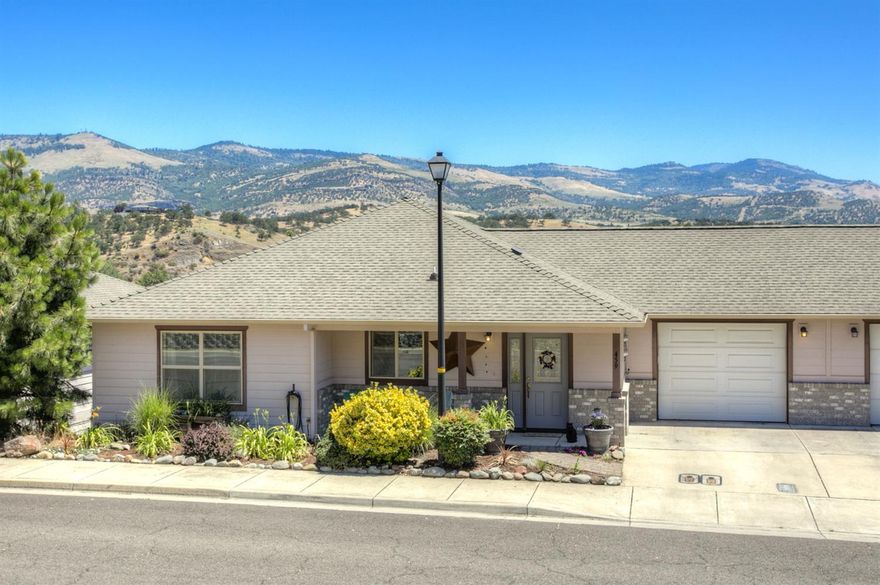 Stunning views from this move-in ready hillside town home! Enjoy the mountain views from the back deck off the main level. Two spacious bedrooms and two full bathrooms. Open floor plan with great natural light throughout. The kitchen offers ample counter space, granite counters and wood flooring. entry and bathroom floors are tiled. The living room has a vaulted ceiling and a gas fireplace. Fenced backyard. There is a full unfinished basement to easily add additional bedrooms, a family room and/or bathroom.