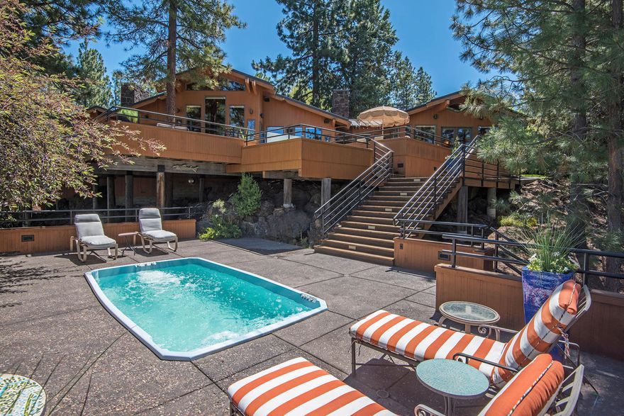 An exquisite home with a gourmet kitchen featuring a custom island topped chiseled edge granite, two Sub zero's, two dishwashers, Wolf gas range with a custom handmade copper range hood. All this is open to the great room all of which has outstanding views to your favorite Cascade peaks, black walnut hardwood flooring, hand selected wood beam accents throughout, a Central Oregon inspired rock fireplace. The bonus room has its own stone fireplace and is currently used as an office; this room would easily make a fantastic family space. Each bedroom is appointed as a complete suite. The multi tiered west facing decks make for inspiring outdoor living. Hit the swim spa/lap pool before dipping into the hot tub to soak while taking in the sunset. For all of your Bend lifestyle toys there are 2 detached garages, an oversized three car plus with finished space above that can be used as an office or studio & a standard two car garage which possibly could be converted to a casita/ADU.