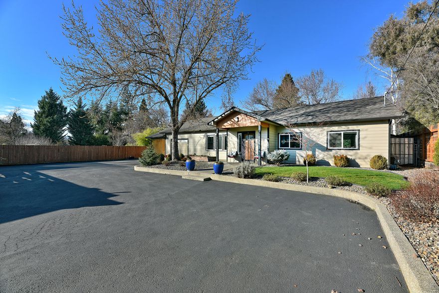 Rare Find! Custom single story home in Old East Medford on beautiful .43 acre lot completely redesigned and brought back to life in 2013.  Home offers a brilliant floor plan and loads of upgrades including raised ceilings with multiple skylights, an extensive lighting package, and a complementary assortment of tile, hardwood, and granite.  Kitchen is well appointed and features an upgraded appliance package, custom cabinets, pantry, and large island bar with prep sink in an open concept to the eating area and family room. There is a cozy wood stove in the family room too.  A large covered back patio overlooks the expansive and beautifully landscaped yard featuring two additional storage sheds, mature trees, and raised garden beds.  This home sits well back from E. Main offering ample asphalt parking, a large carport and a deep 360 sqft one car garage, plus a small private office area that looks out to the back yard. Truly a must see property.  Schedule your appointment soon.