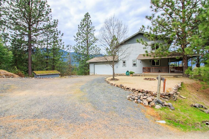 Custom built home on the top of the world. Amazing view across the Wagner Creek Valley to the city lights. Private location. Open concept, can be one level living, wood burning fireplace, high ceiling in living room, wood floors, built-in book shelving, beautiful wrap around wood deck, concrete siding, excellent well plus holding tank, large detached 1800 square foot shop currently set up for woodworking, plus a separate attached two car garage. Hot tub included. Seller will credit buyer $5000 at COE to add walls to 3rd bedroom.