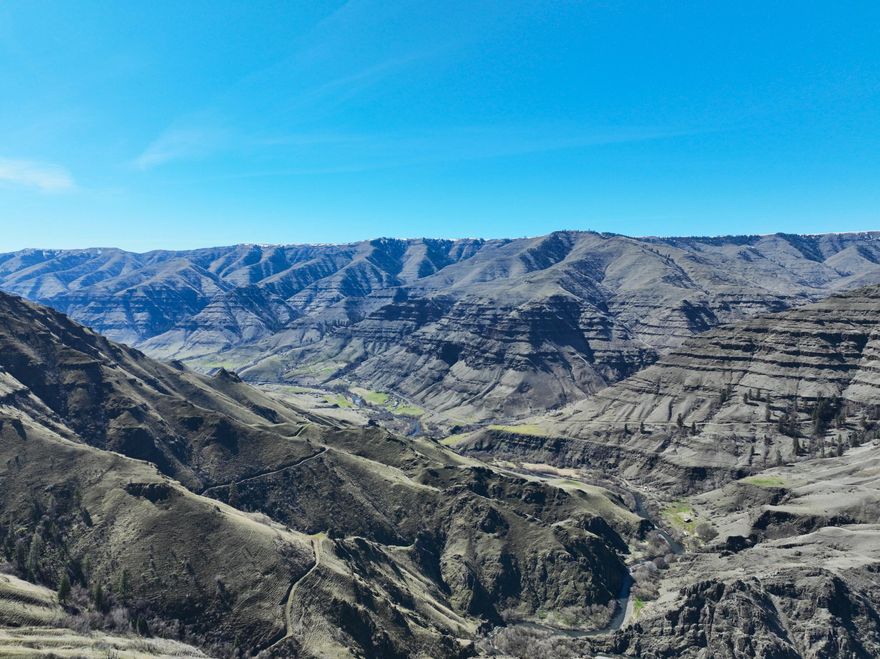 Just across the Imnaha River from the Zumwalt Prairie, The Basin Creek Ranch is a once in a lifetime opportunity. A chance to own a recreational property with an abundance of hunting, fishing and wildlife viewing which includes Monster Rocky Mtn Big Horn Sheep, Trophy Elk and Trophy Mule Deer along with many other animals. Easy access to the property and a road that meanders along the west edge makes it easy to take in the many views, plan a stalk on a big muley or just watch the many chukars, soaring eagles and turkey that inhabit the area. The ranch may qualify for three Landowner Preference Tags for deer and elk. 
The Imnaha River flows along the west edge of the property for about a mile and includes the well-known oxbow river bend. The Imnaha River is home to summer Chinook salmon, native Steelhead, Bull-Trout and Rainbow Trout. Basin Creek cuts through on the northerly end and numerous springs, some of which have been developed, provide a natural place for animals to gather.