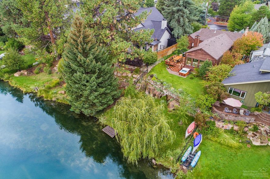 Enjoy riverfront living with amazing river views, direct river access & dock just moments from the Galveston corridor, Downtown Bend & the Old Mill. This charming home was originally built in 1940 w/an addition & timeless remodel done in 1990. Boasting 1589SF plus a finished basement offering an addt'l ~400SF. An inviting living room w/wood fireplace & vaulted ceilings opens into a well-appointed kitchen & adjacent dining room featuring a river view. Welcoming details throughout include wood floors & wood framed windows. A second living area/flex space flows nicely to the guest suite. Fall in love w/the spacious master surrounded by floor to ceiling windows framing the Deschutes River & direct access onto the expansive cedar deck overlooking manicured lawn & mature fruit trees down to the river. Finished basement completes the home w/an office, storage room & W/D. Incredible & rare opportunity to own this one-of-a-kind home on one of the best river front lots in Bend!