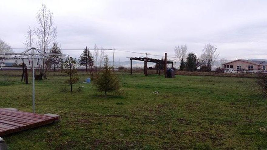 Build your new house or bring a new dbl or triple wide. Flat land 1.9 acres with good well per sellers with RVS sewer, no septic to deal with. The 2bed, 1 bath M/H included is in good shape & functional. Rent was $700 month. Includes heat pump and is all fenced. Short owner financing with substantial down. Not a bank distressed sale.