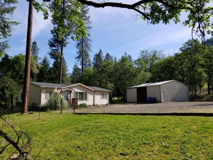 This home is just a few minutes walk to the beautiful Rogue River where you have private access to an area of the river for picnics or fishing. Access to this area is granted by the Cove Association only to its residents. The 3 bedroom, 2 bath home is in a quiet setting with a large shop. Inside the shop is an insulated 15X12 room. The large .49 acre lot has plenty of room for a garden and room for the kids to play. there is also plenty of parking for an RV possibly even room in the shop.