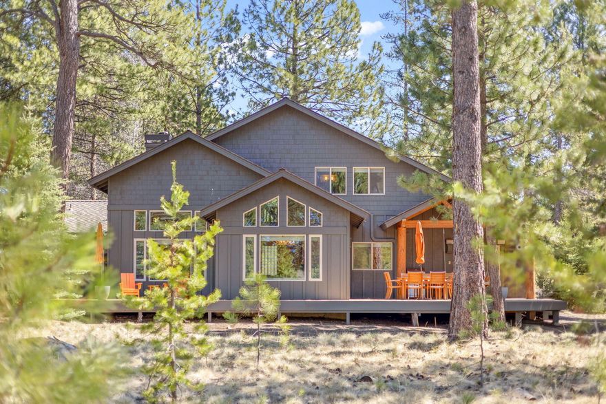 Luxury lodge-style home in a quiet Sunriver setting with four spacious suites—three on the main, plus an upstairs suite with loft. Open great room with soaring ceilings, hand-hewn staircase, and tall windows framing high desert views. Chef's kitchen features a brand-new 36'' gas range, 2 dishwashers, and spacious dining area. Enjoy gas fireplaces in the living room and primary suite, multiple decks, large hot tub, and custom garage with cabinets and floor coating. New roof (2017), furnace (2017, ducts cleaned Apr 2025), and water heater (2016). New bedroom blinds and fully furnished with Restoration Hardware and Pottery Barn pieces. A stunning retreat in the heart of Sunriver.