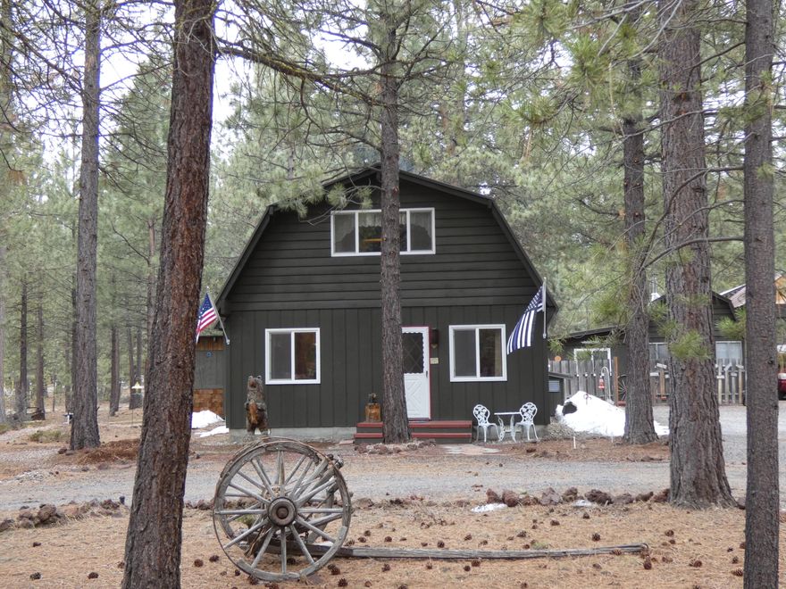 Amazing home, guest house, RV cover with hookups, and giant shop all come together to make this the perfect gathering spot. Main Chalet house is 3bd, 2ba with good size bedrooms. A newer certified wood stove and heat pump provide great heat and air conditioning. Shop is 36x40, 3 large bays and 12 foot carports on each side and in back. Guest house is approx. 450 sqft with a kitchen, living room, 1 bd & 1 ba. Separate RV cover with septic hook up and electricity. All of this located on over an acre of beautifully groomed landscaping with old growth ponderosa trees. No water worries here as the property is hooked up to the Ponderosa Pines water district. So many features you must come and view this home.