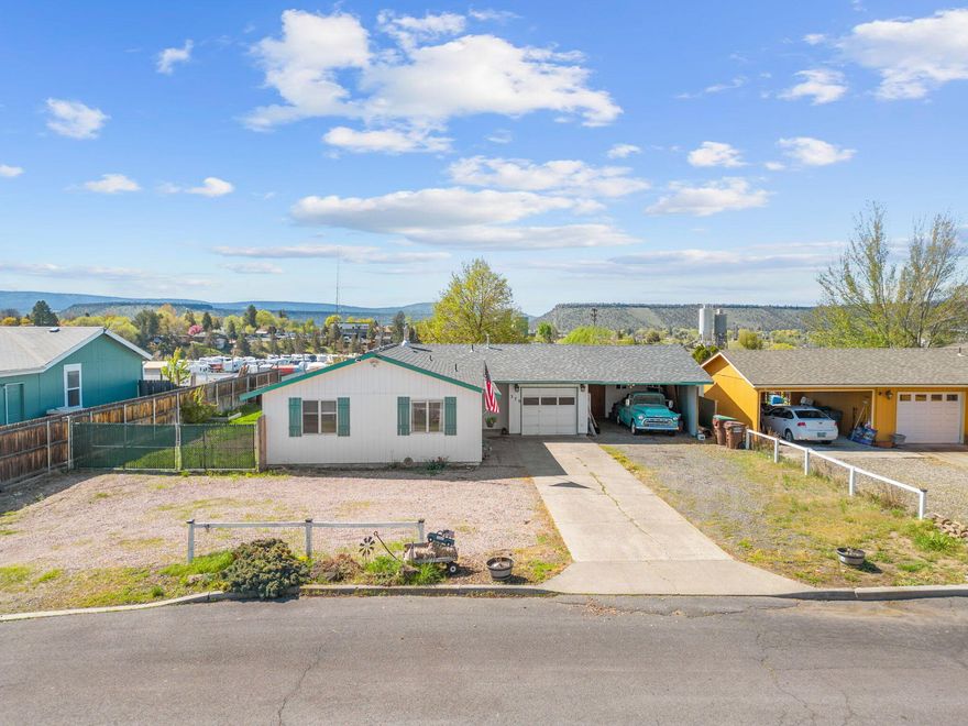 Charming 3 bedroom 1 bath home with an updated kitchen. New subway tile backsplash, painted cabinets, & laminate wood flooring. Living room has large windows to let
all the natural light in & also has gas stove for efficient winter heating. Dining room is right off the kitchen with a slider to the back patio. Three nice bedrooms and one full
bath with shower/tub combo, new vanity, and updated floors. There is also a bonus room outside, which is perfect for accommodating guests or serving as a private office.
Oversized lot in a great location, close to town with panoramic views of the city of Prineville. Backyard has covered patio, storage shed,
flower beds, underground sprinklers, and plenty of room to BBQ. The carport w/ workshop is perfect for those who enjoy working on projects or working on vehicles.
Plenty of RV/Boat storage.