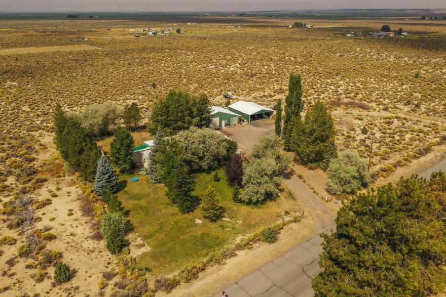 7.81 acres right on the Edge of Town close to the downtown park and amenities. Corner of Christmas Valley Hwy and Rainbow Rd, the house and shops are situated toward the back of the property away from the Hwy. Lots of room for horses, farming, parking or more shops. A nice little portion of the home upfront has been utilized for a small business with a separate entrance or could be used as the 2nd bedroom/mother-in-law. Fantastic shop with loft area and additional large covered parking structure. 16x16 Covered Porch off the Primary bedroom with a nice hot tub that may be included in the sale. Motivated Seller is currently removing many items so the property will be changing rapidly.