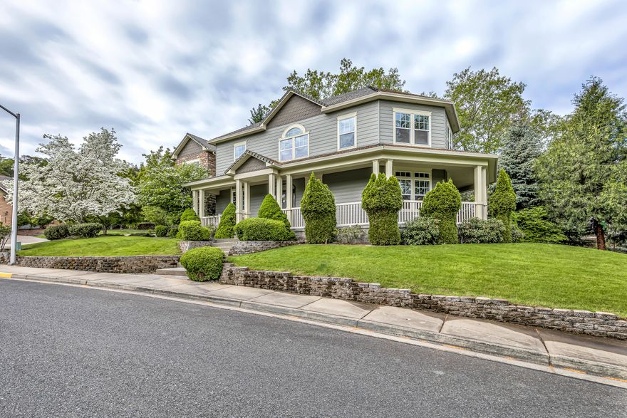 Experience luxury living in the prestigious Meadow Wood Subdivision! This custom-built masterpiece offers over 3,000 sqft of exquisite design, soaring ceilings, and impeccable craftsmanship. Featuring 4 bedrooms and 3.5 baths, including two primary suites—one on each level—this home is designed for ultimate comfort and convenience. The spacious living room is highlighted by a gas fireplace, while the gourmet kitchen boasts a large island, top-tier appliances, and an elegant dining area with patio access. The main-level primary suite features a walk-in closet and ensuite bath, while the upper-level primary suite elevates luxury with its own fireplace, expansive walk-in closet, and spa-like ensuite. Upstairs, enjoy a large bonus room with breathtaking views and two additional bedrooms. Step outside to a serene back patio and covered wrap-around porch overlooking manicured grounds and a charming gazebo. A 2-car garage with a workshop area adds functionality.