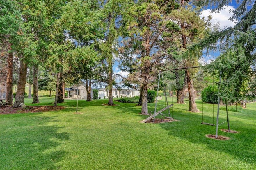 A rare opportunity to own a secluded piece of pure Central Oregon living just 2 miles from Bend. 120 acres supports the farm and ranch lifestyle with grass hay production, irrigated rolling pastures for livestock and horses, dryland farming, and 3 ponds. Grow your own food, raise your own animals, explore crop cultivation and more, it's all possible. Lovely pastoral views from the single level home set amongst lush grass, towering pines and a meandering irrigation canal. Here you'll find all the essential facilities, infrastructure and outbuildings that support a ranch complete. Cascade mountain views from some portions of the property. This protected parcel sits 2/3 of a mile from the road and is bordered by public land.