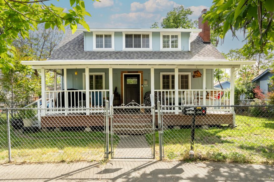 Step into a delightful piece of history with this charming home, perfectly capturing the essence of the early 1900s. You'll immediately feel at home on the inviting covered front porch. As you enter, the expansive living room welcomes you with a stunning stone fireplace, creating a warm and cozy atmosphere. The flow from the living room to the dining area and futher on ito the updated kitchen . The kitchen has plenty of cupboards and counter space to enhance your cooking abilities.

The primary bedroom, conveniently located on the lower floor with its own en suite bathroom, ensures comfort and privacy. Upstairs, you'll discover four additional bedrooms and a full bath, providing ample room for everyone to unwind. Outside, the fully fenced yard features a lovely patio, alley access, and a garage/shed, perfect for all your outdoor needs. This home is truly a wonderful place to create lasting memories!