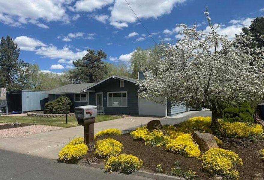 First time on the market!  Welcome to this inviting Shepard Road Cottage now available.  Single-level  is situated on the lovely curving Shepard Road in an iconic area of Bend's popular mid-town area.  3 bedroom has a mid-century modern flair with the covered front sidewalk.  Lovingly maintained with newer windows, roof, gas fireplace, plumbing fixtures, tile, fencing, and more.   Attached and detached garages  (both have paved driveways, man doors, electric  door openers)   plus covered RV carport, too.  Established  landscaping includes perennial plantings through-out the fenced-sprinkled yard.   You'll love the enclosed patio, storage/garden shed, greenhouse.  Located in picturesque treed neighborhood just steps from Hollinshead, Stover Park and Al Moody Parks, near the Eastern hiking trails, and Pilot Butte!   It's  close to schools, medical, church, shopping, parks, trails, in convenient location.  Charming, spotless, bright, and move-in ready. Better call now.