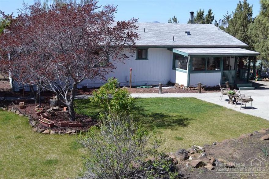 Bring your horses to the this charming stick built home, right on the paved road on 2.39 acres. Fully fenced and gated property with privacy minutes from Apple, Facebook, schools and new hospital. Home features 3 bedrooms and 2 baths with a dog kennel and carport. Cascade mountain views. mature deciduous trees and landscaping make it easy to relax on the back patio and covered porches. Bunkhouse with heat, electricity and windows to Mt Jefferson. Shop with electricity, water and drains.