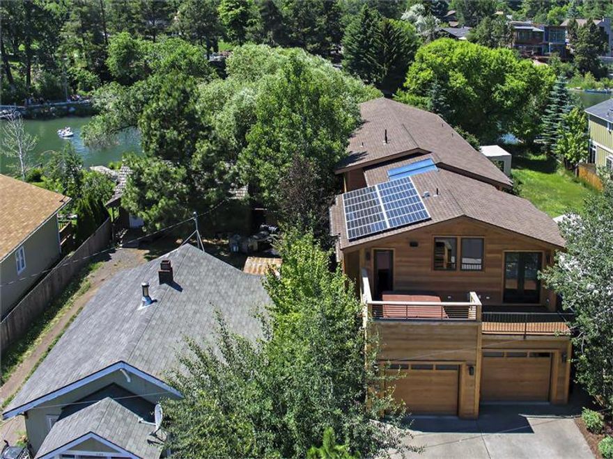 Amazing home built in 2008 & remodeled in 2012, sits right on the river across from Columbia Park. Home includes 2 master suites (1 up, 1 down), 2 offices, upstairs & downstairs laundry, media rm w/black out curtains & blinds, bonus rm w/separate full size built in fridge & dishwasher, radiant floor heat, concrete floors on the main level w/hickory hardwood floors upstairs. All surfaces are custom concrete counter tops w/the exception of the full bath down. Home has a solar voltaic & solar hot water system.