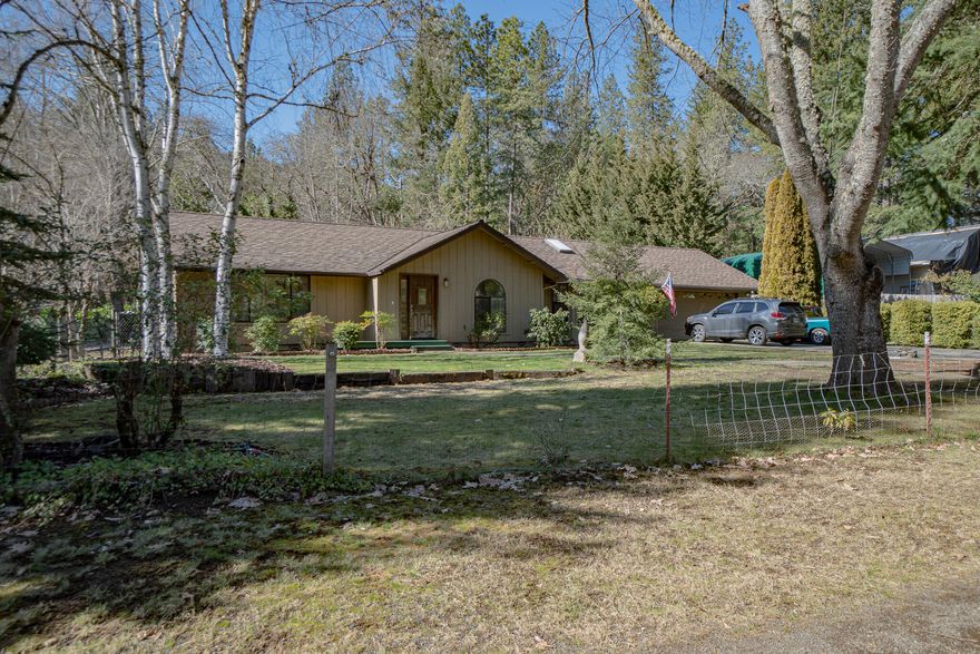 This is a Must see! Charming one story ranch style home with a flat usable 1.49 Acres! The Kitchen has been recently remodeled with new high end appliances, Granite countertop and huge Island. Primary bathroom has been remodeled and beautifully done. New flooring throughout and vaulted ceilings highlight this beautifully done home. Park-like setting backyard with a small barn, green house and storage shed with power and plumbing. Has a HUGE 30X40 Fully permitted and finished shop with Concrete epoxy coated flooring and 110/220 Power and 50 amp RV Hookup, a must have! Tons of parking and privacy as this home is tucked away off of W Evans Creek with a private driveway! Don't miss out and call for your tour today!