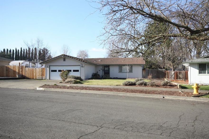 Great East Medford Home! Convenient location near hospital and shopping. 3 Bedroom, 2 bath with sunken living room and vaulted ceilings, tiled roof and wood burning stove in the dining room. Newer wood laminate throughout the house, interior painted, and new carpet 2 years ago. Large lot with 384sqft insulated and heated shop. RV parking and a great backyard with covered cement patio. This is a great place to call home. Listing agent is related to sellers.