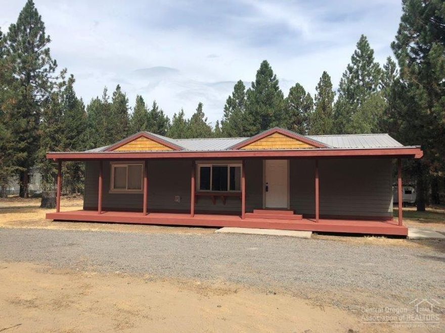 Turn key & move in ready! This adorable 1188 sq ft home sits on a nearly one acre treed lot providing great privacy. 3 bd 2 bth, master separation w/ walk-in closet & floor to ceiling sliding windows, large utility room leads to sunroom on back deck. Oversized front porch spans full length of home. Circular driveway, storage building w/ power, RV hookups & large dog kennel. Recent updates include new back deck, fresh paint inside and out, new tile flooring, & new exterior skirting.