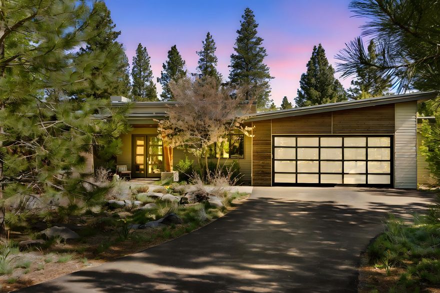 Nestled in the prestigious Tetherow community, this single-level home, boasts three bedrooms with good separation between primary and 2 guest rooms,  two and half bathrooms, and an oversized garage.  The open-concept layout includes a gourmet kitchen with a large island, quartz countertops, and high-end appliances. The primary suite offers a soaking tub, tile shower, and walk-in closet. Floor-to-ceiling windows flood the space with natural light and provide stunning views of the golf course.  A spacious bonus room and private office space make for a really great floor plan. The outdoor living area is equally impressive, featuring a covered patio, and accordion doors that allow for easy indoor/outdoor living.  Residents enjoy access to Tetherow's world-class amenities, including golf, pools, fitness center, trails and dining options.