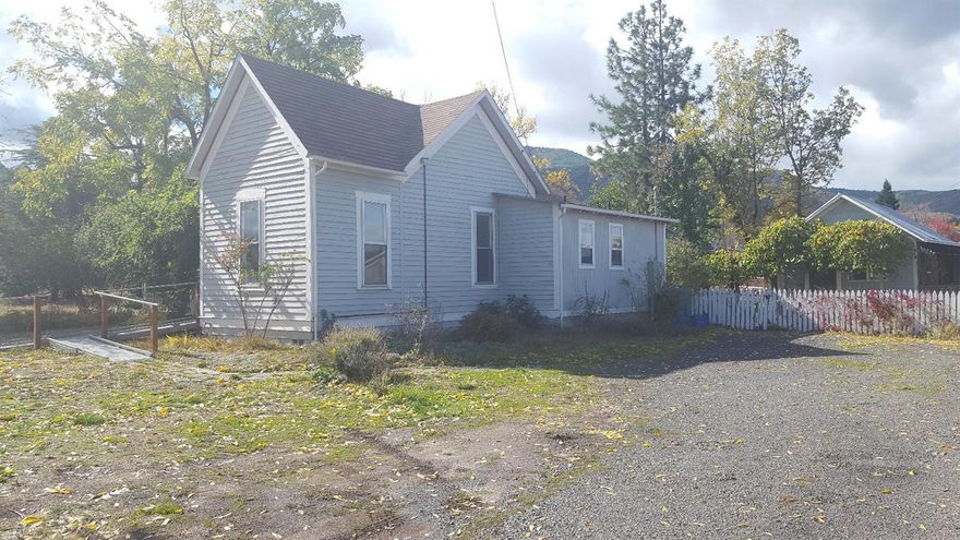 Rare opportunity to own two homes in Ashland. Centrally located on a spacious and usable .40 acre lot. Main house is two bedrooms, 1 bath and approximately 970 sq. ft. It features an open kitchen, high ceilings, wood floors and a wheelchair friendly bathroom and front access. It also has central heat and great natural light. Detached is a 1955 built studio style rental unit with 337 sq ft. It also has nice natural light and a full bathroom. Buyers to conduct their own due diligence on future development potential and are encouraged to verify all listing details as Seller is a representative of the family and has never lived in the home personally. Nice views, mature landscaping, lots of off street parking.