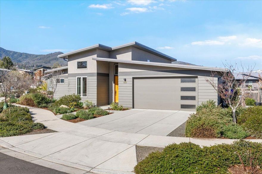 Nestled in the coveted Verde Village neighborhood of Ashland, this stunning, Earth Advantage Platinum-certified home is the epitome of modern, sustainable living. Incredible views of Mt Ashland! Eco-friendly features with luxury living ensure comfort & efficiency. The single-story split floorplan offers 3 spacious bds + den/office. Step inside to discover Brazilian cherry flooring that flows throughout the home, complemented by a gas fireplace with custom tile surround & built-in cabinetry. Vaulted ceilings & an abundance of windows for natural light. High-end stainless appliances, including a 5-burner cooktop, wall oven, convection oven & large kitchen island w/seating. Outdoor patio offers views & low-maint. landscaping for easy enjoyment. Oversized garage features custom cabinet system, workbench & Chargepoint EV charger. Solar panels for enhanced efficiency. Located in a zero-energy ready community, this is a rare opportunity to experience sustainable luxury living at its finest!