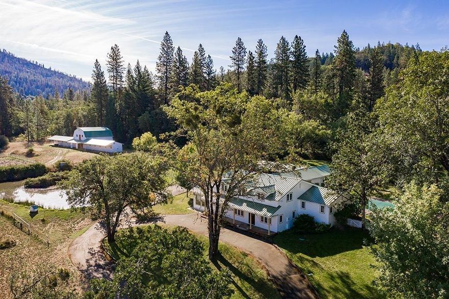 21+ Acre Horse Ranch with custom 3000 sq ft home and a 14 Stall Barn. This is a Must See Property !!! This spectacular secluded Ranch only minutes from Grants Pass was built as a professional horse breeding facility. It features a gated entry and paved driveway to the 4 bedroom 3 bath home, with swimming pool, 2 car garage with attached bonus room, 800 sq ft covered trex deck, The property is level with a mix of pasture and woods zoned WR for low taxes and fronts two streets. Year round pond and a seasonal creek flows through an additional large winter run-off pond. The custom cedar 4000 sq ft barn has a 1000 sq ft hay loft, bathroom, tack room, feeders and water in all 14 stalls of which 12 are run-in stalls with rear corrals. There are 2 fenced pastures and riding area near the barn & 10+ acres in the back. The Applegate Wagon Trail had passed through the property as referenced on a 1850's survey. Price reduced is for some needed improvements & is Firm AS IS. Agent related to Seller