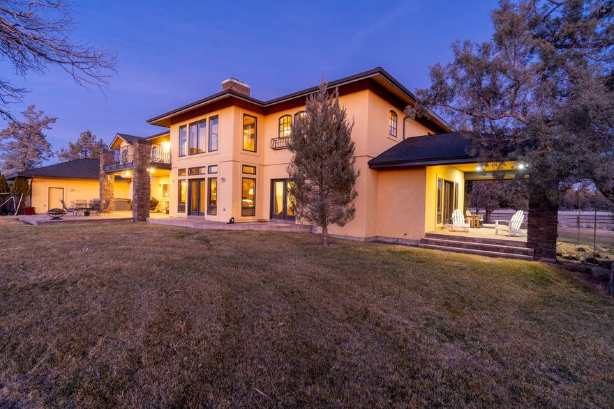 Presiding over 20+ acres in Bend Oregon this 6,705 sqft Mediterranean style villa exudes sophistication and clean elegance. The home spans 2 levels of
timeless contributions and the highest level of craftsmanship and quality. The many amenities include a stately entrance with a towering staircase and intricate
railings. Heated colored concrete floors and knotty alder accents span the main floor with Hickory wood floors and tile upstairs. A commanding stone fire place
in the great room with see through fireplace into the chefs kitchen. Primary bedroom suite offers sitting room with fireplace and deck with views expanding to the Cascade Mountains. 4 additional bedrooms, 2 office spaces, game room and large laundry room and mud room with full bath. Additional accessory building that would be a great studio or separate office, barn and storage building. 8 acres of irrigation.