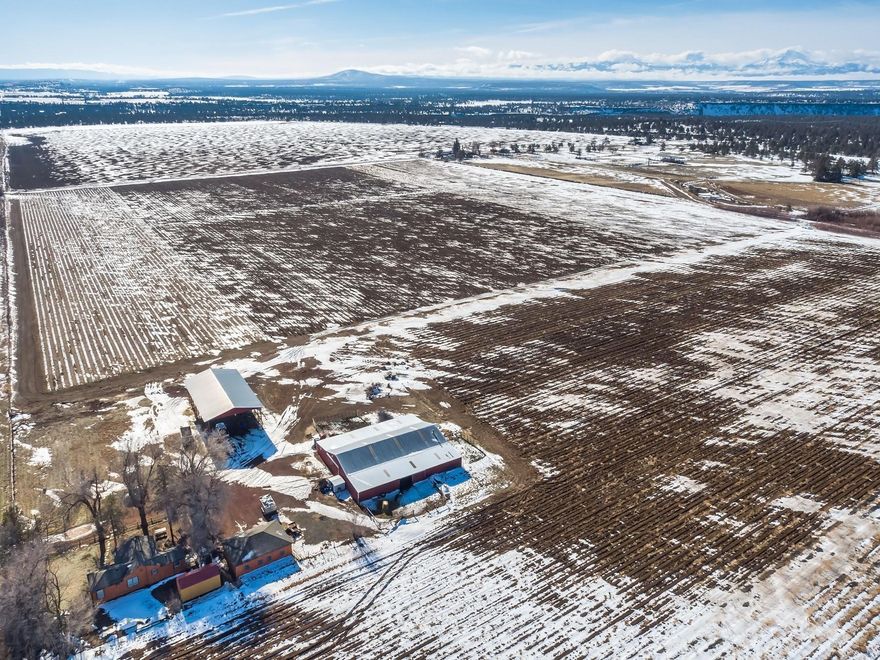 Culver Farm with Cascade Mountain Views. Property is 77.2 acres with 75.1 acres of NUID irrigation water rights. Irrigation system is 4 wheel lines and will be planted in a grain crop the spring of 2021. Infrastructure includes: 1 bedroom, 1 bathroom cottage, horse barn with stall, tack room and hay barn. Property is 10 minutes to Redmond or Madras.