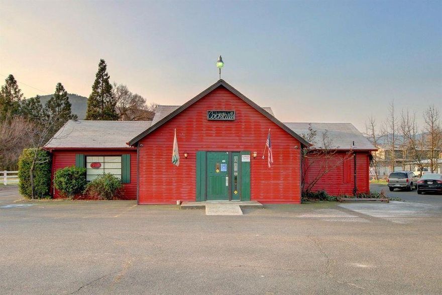 Fantastic opportunity to own a former tavern/ lounge with the real estate in desirable Talent, Oregon! The property consists of over 3000 sq. ft. on a large .42 acre lot with plenty of parking. Great location between Ashland & Talent on busy South Pacific Highway! There is an outdoor covered seating area as well as an upstairs office area. The sale includes all kitchen equipment and furniture. Dynamic location for someone to come in and create their own business venture in this growing community.