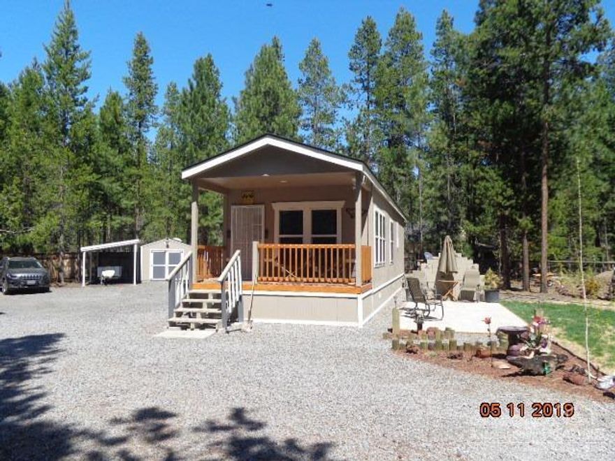 One of a kind setting with all the comforts of mountain living in an almost new (2017 672 sqft.) single wide manufactured home. Located in a friendly neighborhood with living options for a 2nd home, retirement and/or small primary residence. Completely fenced, landscaped on a 1/2 acre secluded park like setting. Upgrades include: Black/Stainless appliances with a 5 burner propane range/stove, finished crown molding, interior lighting and fans, Quada Fire heating propane stove. 2017 newly installed ATT sand filter system, 40 lb roof, 2 Tuff sheds, 2-50amp set up for RV hook ups and your guest, 3 frost free and a Carport for the boat. Maintenance free landscaping with an assortment of pine and spruce trees. Fenced with 2 storage sheds and a spacious size yard for the animals. Down the road is the neighborhood clubhouse, community park and marina for docking your boat. Cash or 50% down offers.