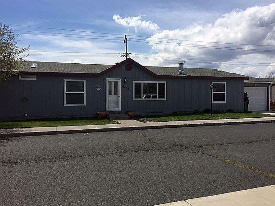 4 bedroom 2 bath manufactured home with 1782 sq. ft. located in the suburbs. Living room plus family room. 2 lots with this property at .26 acres! Huge fenced backyard with carport, room for RV parking and attached 1-car garage. Covered deck outback with trex decking. Newer counter tops, appliances and newer laminate floors.