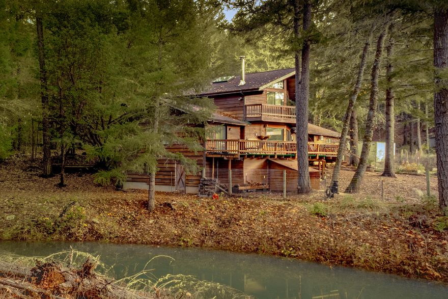 This exceptional farm features two OLCC recreational licenses, 3 large barns, and two home setup set on over 35 acres. Water rights from the adjacent seasonal creek and a winter storage application from the pond ensure a consistent and reliable water supply. The property features two designated, fenced growing areas, and an additional cleared space ready for an additional license, offering expansion potential. The farm's robust infrastructure includes a substantial 600 amps of power and two wells. Living accommodations are provided by a detached 648 sq ft guest home and a beautiful two-story 2018 sq ft main residence. The home is accented with open beam ceilings, tile countertops, tile and hardwood flooring, and stainless steel appliances. Large windows throughout the home offer views of the farm and surrounding mountains.  1801 Davis Creek is an ideal buy checking all the boxes for a successful farm. 
Call for a showing today.