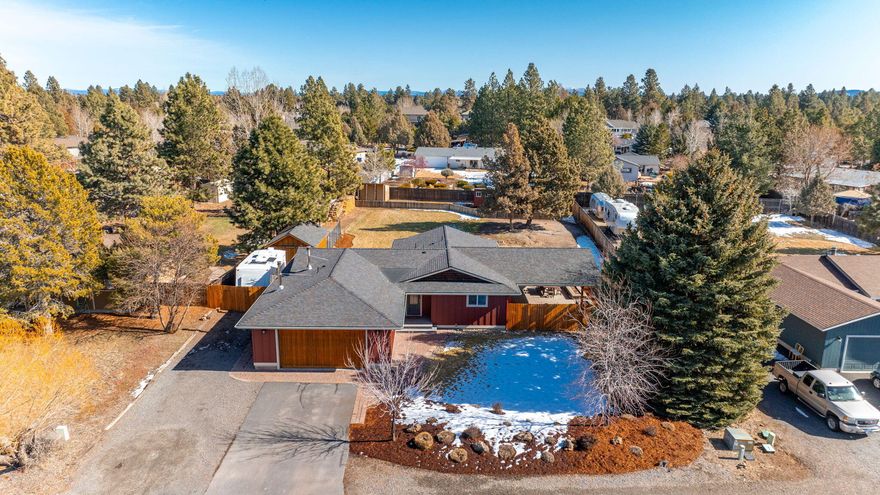 Located just minutes away from Larkspur Community Center, Alpenglow Park, and the new Cascade Lakes Brewery, you will love the location of this turnkey
home in Bend's Desert Woods neighborhood. This meticulously maintained home sits on a huge .48-acre fenced property, offering a parklike backyard, paver
walkways, and a stunning 520 sqft covered patio, offering a fantastic outdoor living experience. Inside, you'll find a modern kitchen with quartz countertops, tile
backsplash, and accent windows, enhancing the natural light. The primary bathroom features a dual vanity and a tiled walk-in shower. The spacious, light-filled
living room is perfect for gathering and staying warm by the wood-burning fireplace. Additional amenities include a ductless mini-split system with heat & A/C, a second woodstove in the garage, 220V in the
garage, RV parking, a storage shed for all of your gear, a garden, chicken coop, and dog run.