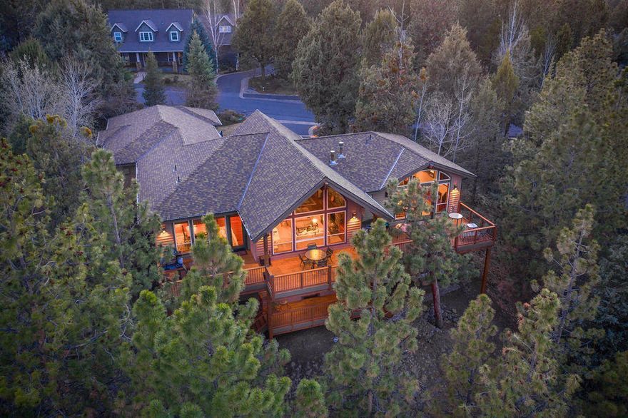 Extraordinary Custom home by DeMarco Design located in the private & gated community of Awbrey Glen on Bend's Westside. Nestled among the pines above the 12th Fairway, the private, contemporary/NW style home sits on .99 of an acre w' Tree Top Views. With 4041 Sq Ft the home has been thoughtfully constructed, w' soaring exposed timbers in the GR & walls of glass for natural light. 3 spacious ensuite bedrooms w' the primary on the main, 3 full baths w' stone flrs & counters, a powder room, 2 add'l bedrooms, office, media room w' wet bar & 1200 bottle temp controlled wine rm.  A chef's kitchen w' slab granite cnters & kitchen island w' bar seating, SS appliances & abundant storage. Cherry Brazilian HW floors, Vertical grain 8' Douglas Fir 3 Panel Interior Doors, Finish Casing & Trim.  Western Cherry HW cabinets throughout w' Patina Wrought Iron Handles. A 1600 sq ft deck serves for a perfect spot for entertaining. 3 car garage w' carriage doors. See Documents for specific details.